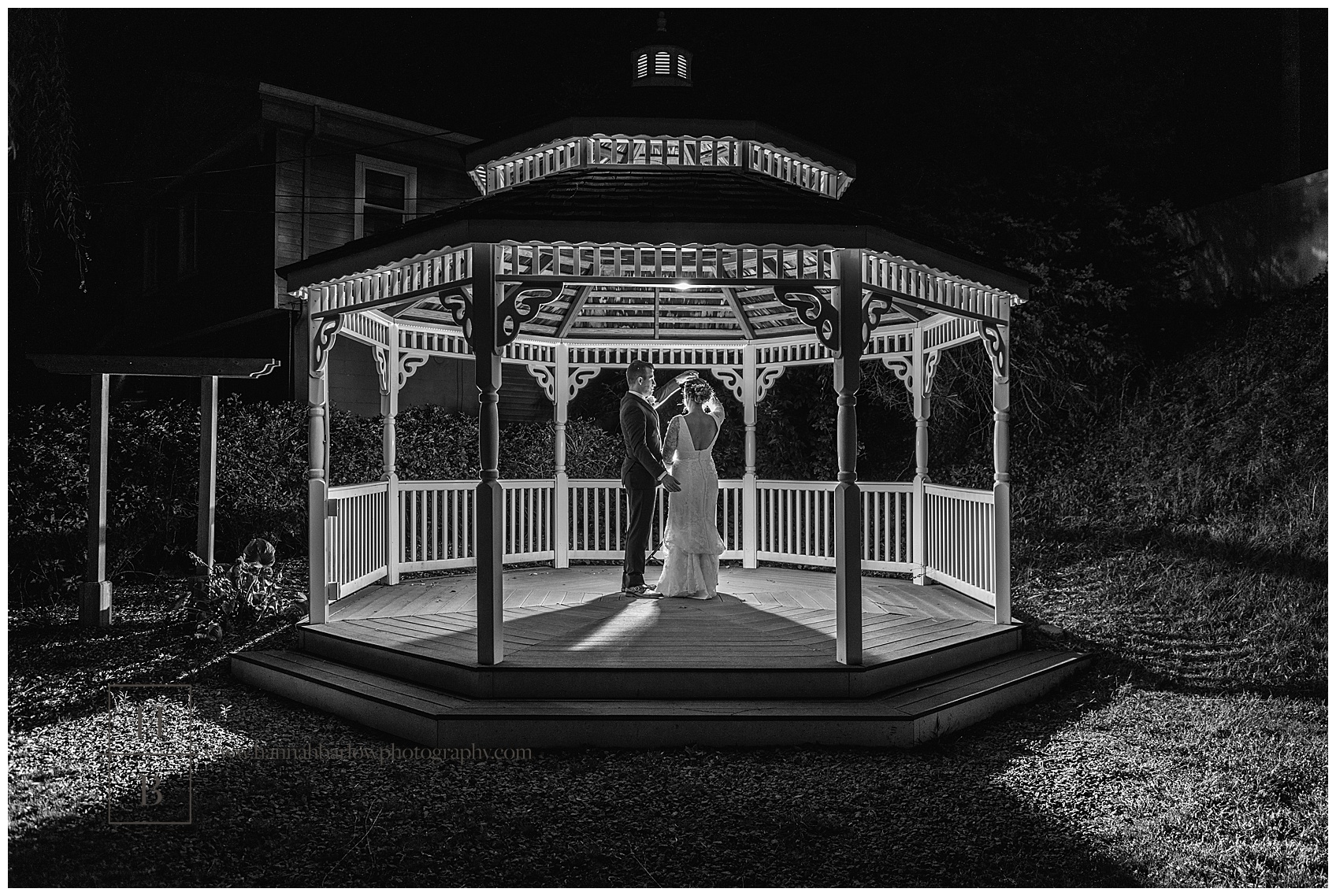 Black and White Photo of Bride and Groom Dancing in Gazebo