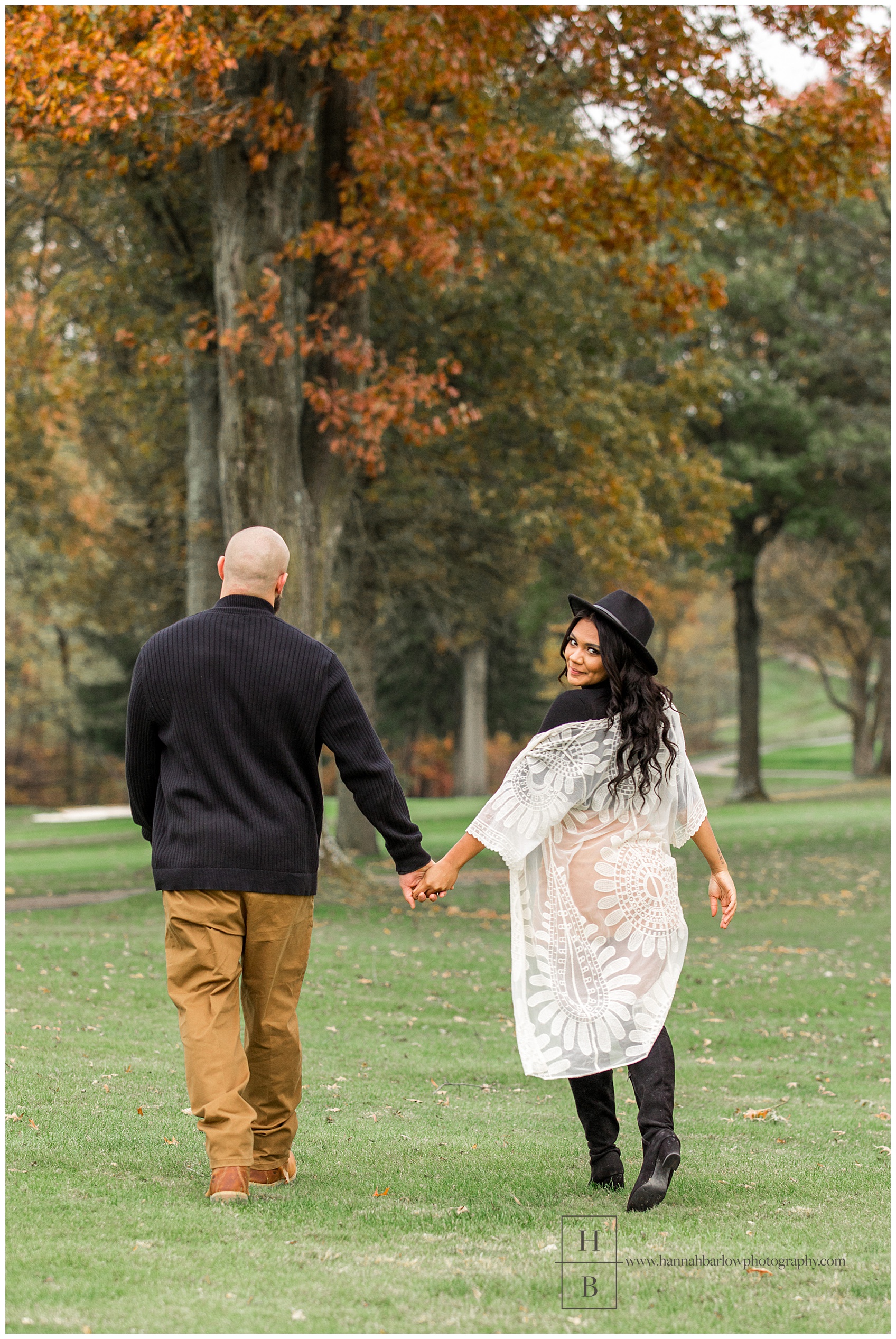 Fall Engagement Photo of Woman Looking Back While Walking