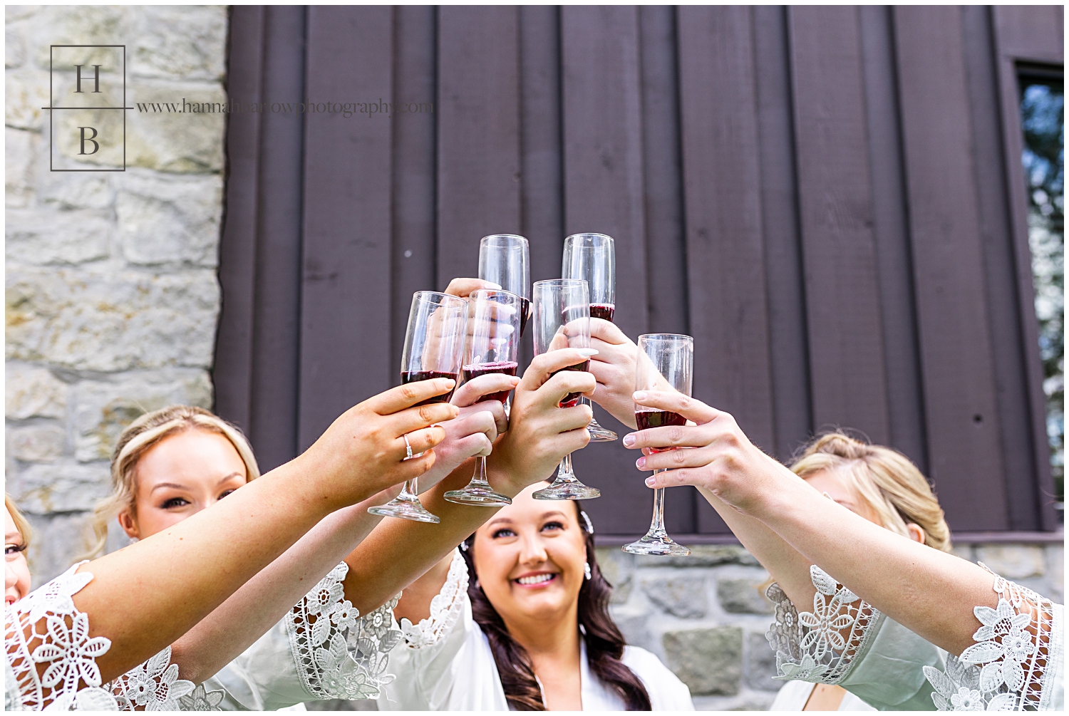 Bride and Bridesmaids Holding Wine Glasses Up to Toast