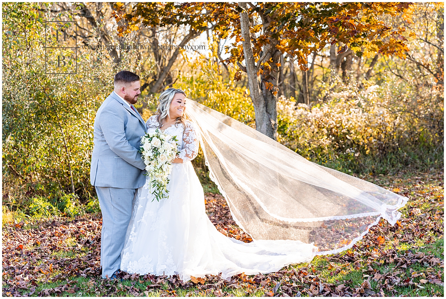 Bride Looking back at Flying Veil with Fall Background