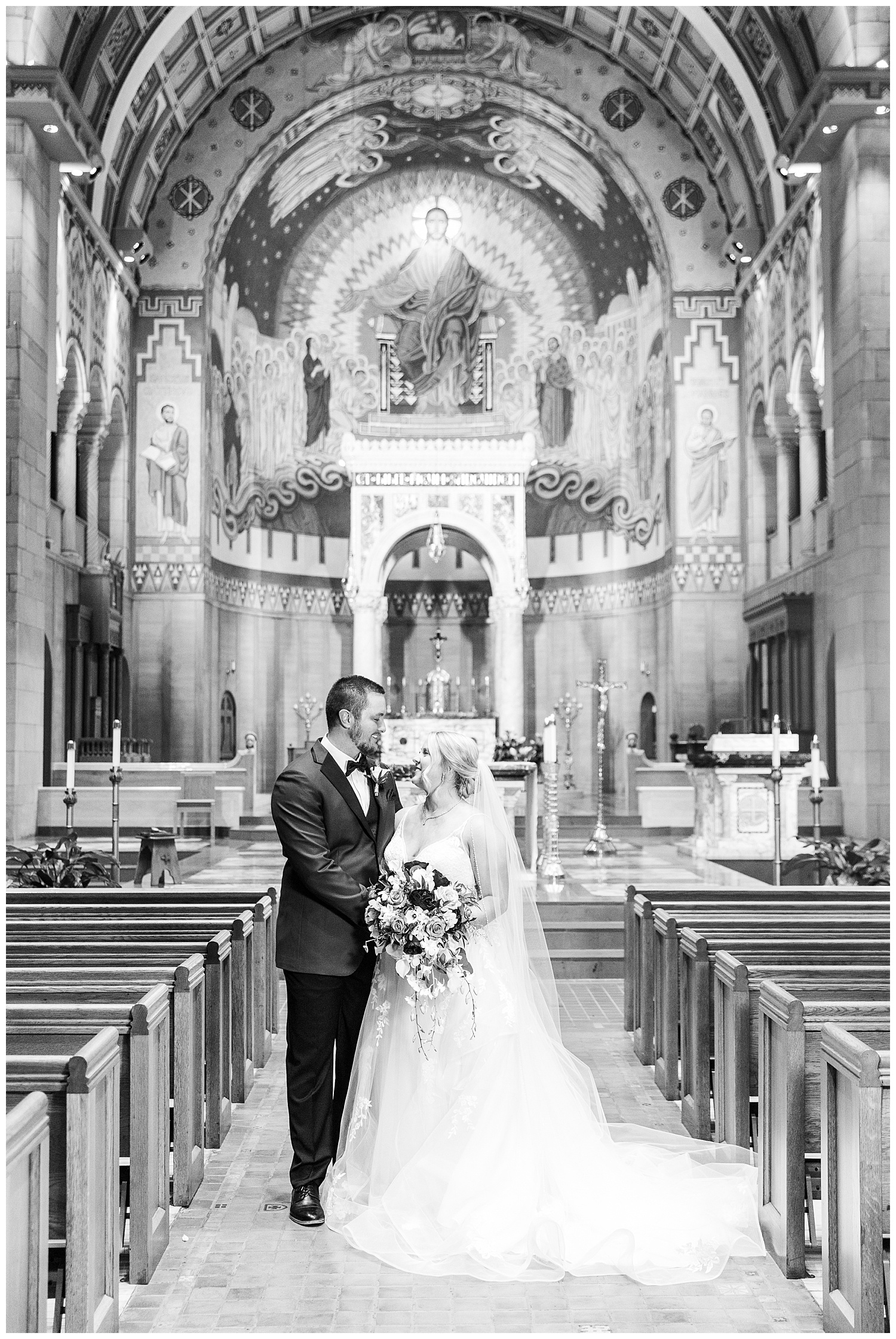 Black and white wedding portrait of couple in church