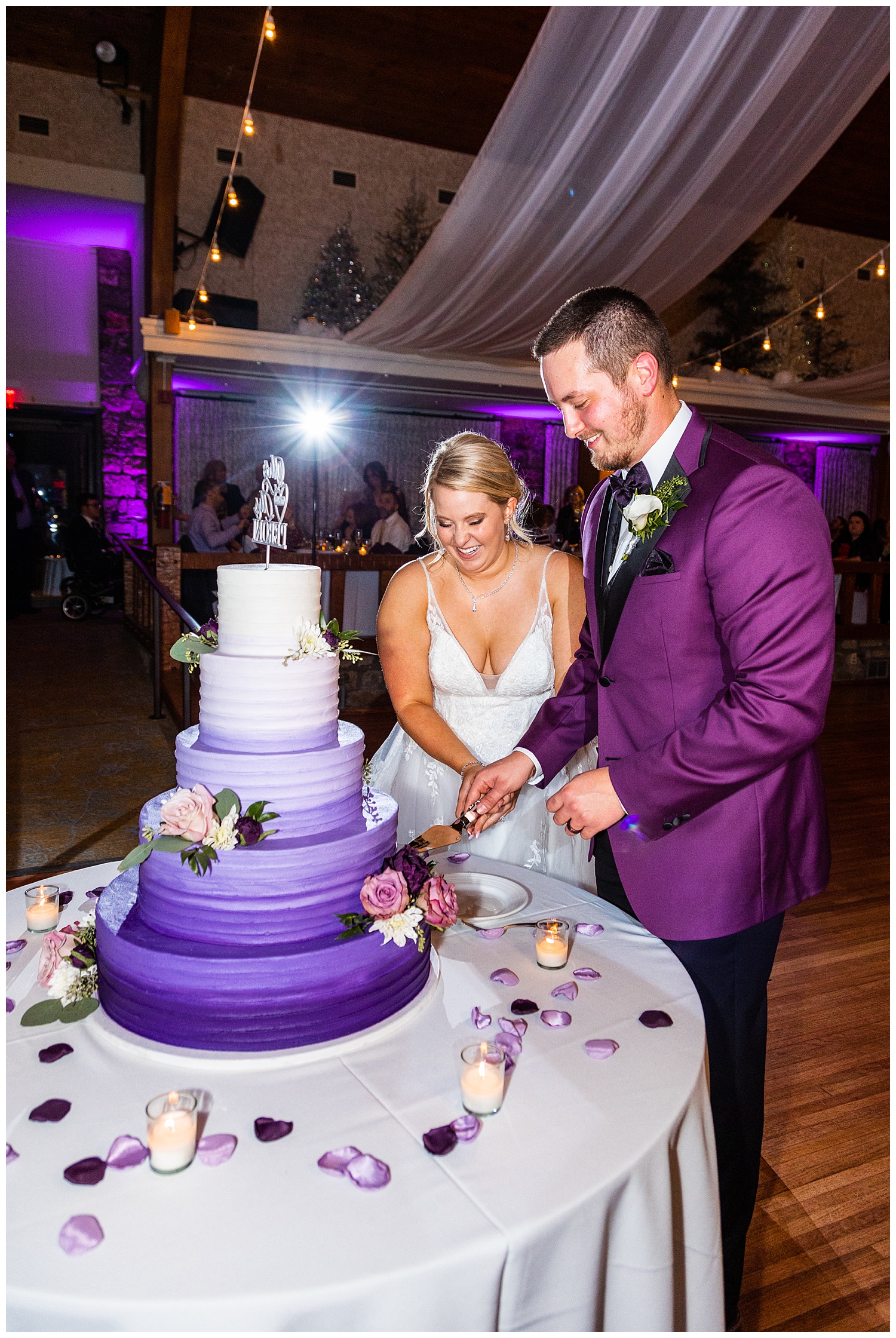 Bride and Groom cut purple wedding cake