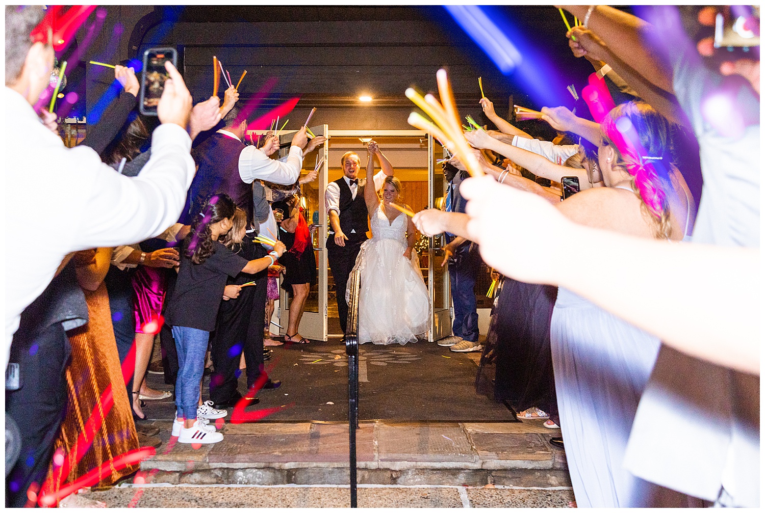 Bride and Groom run out of reception for glow stick send off