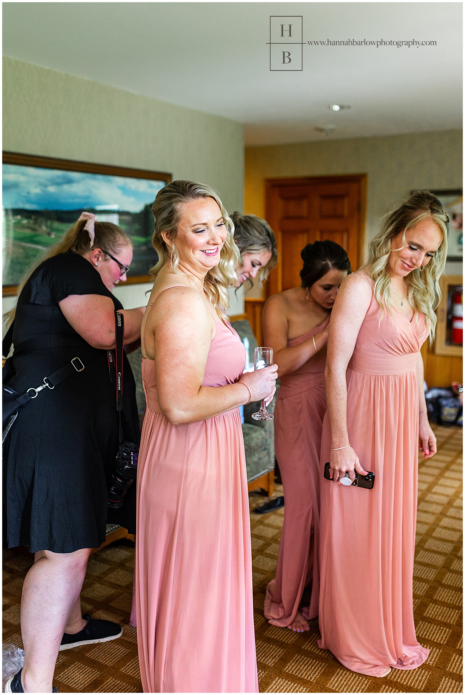 Wedding photographer assistant fixes dresses