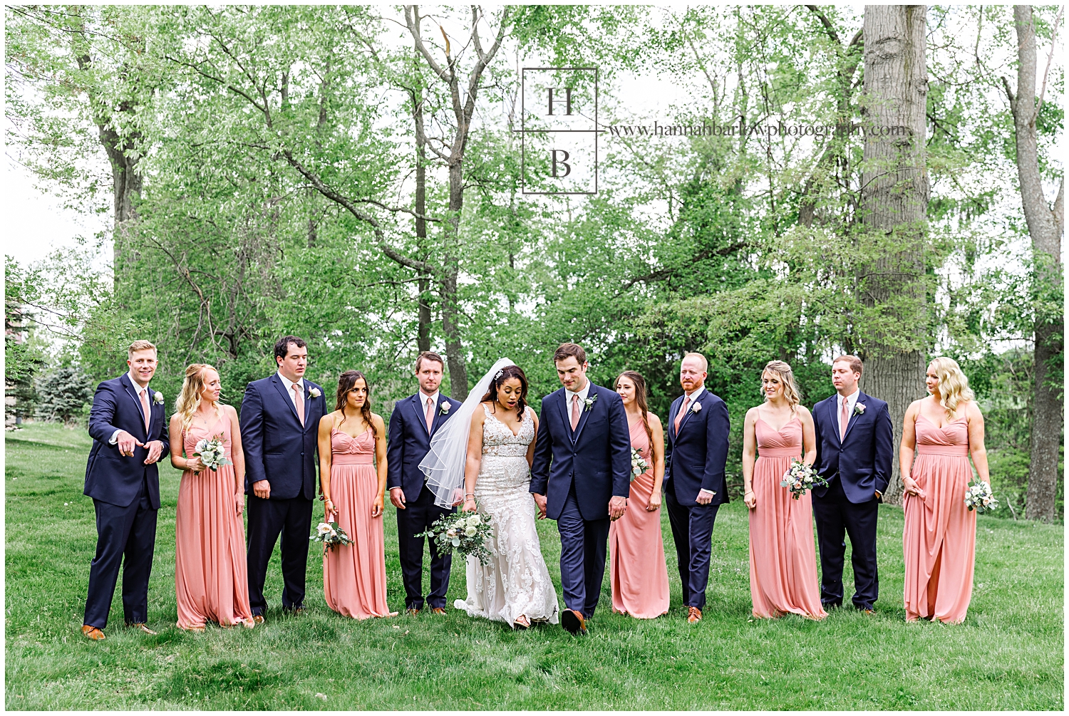 Bridal party avoids stepping in mud while walking.