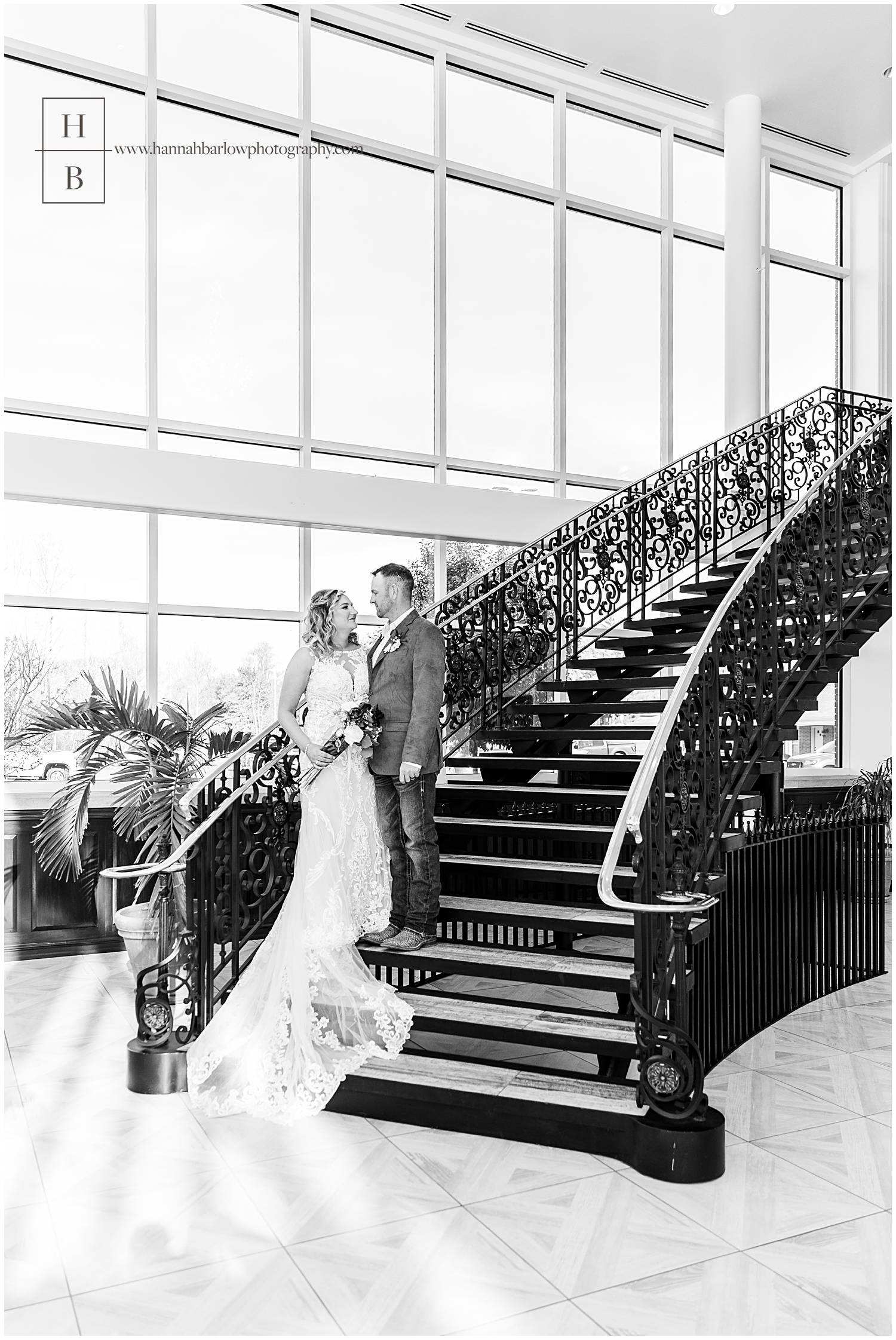 Black and white photo of bride and groom on steps at Willows of PA.
