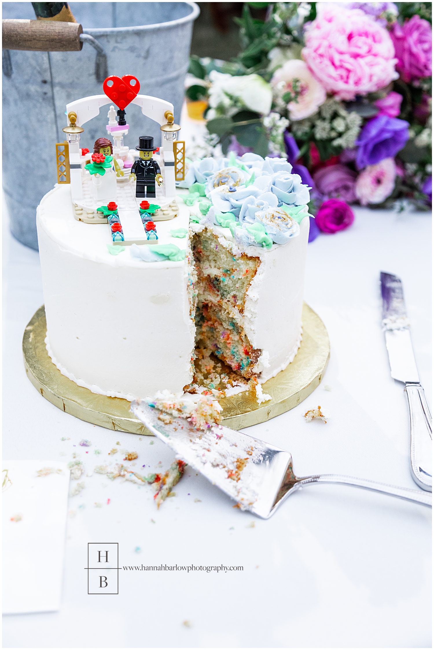 Lego wedding cake is cut featuring confetti icake nside.