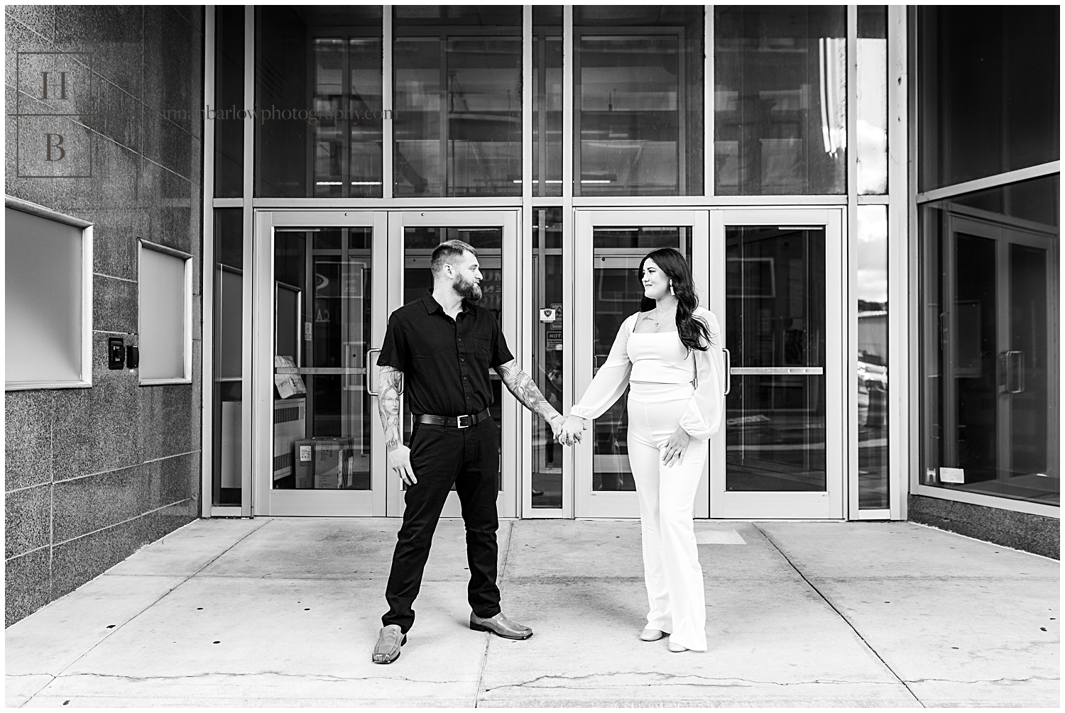 Bride and groom to be pose for photos in front of Wheeling building.