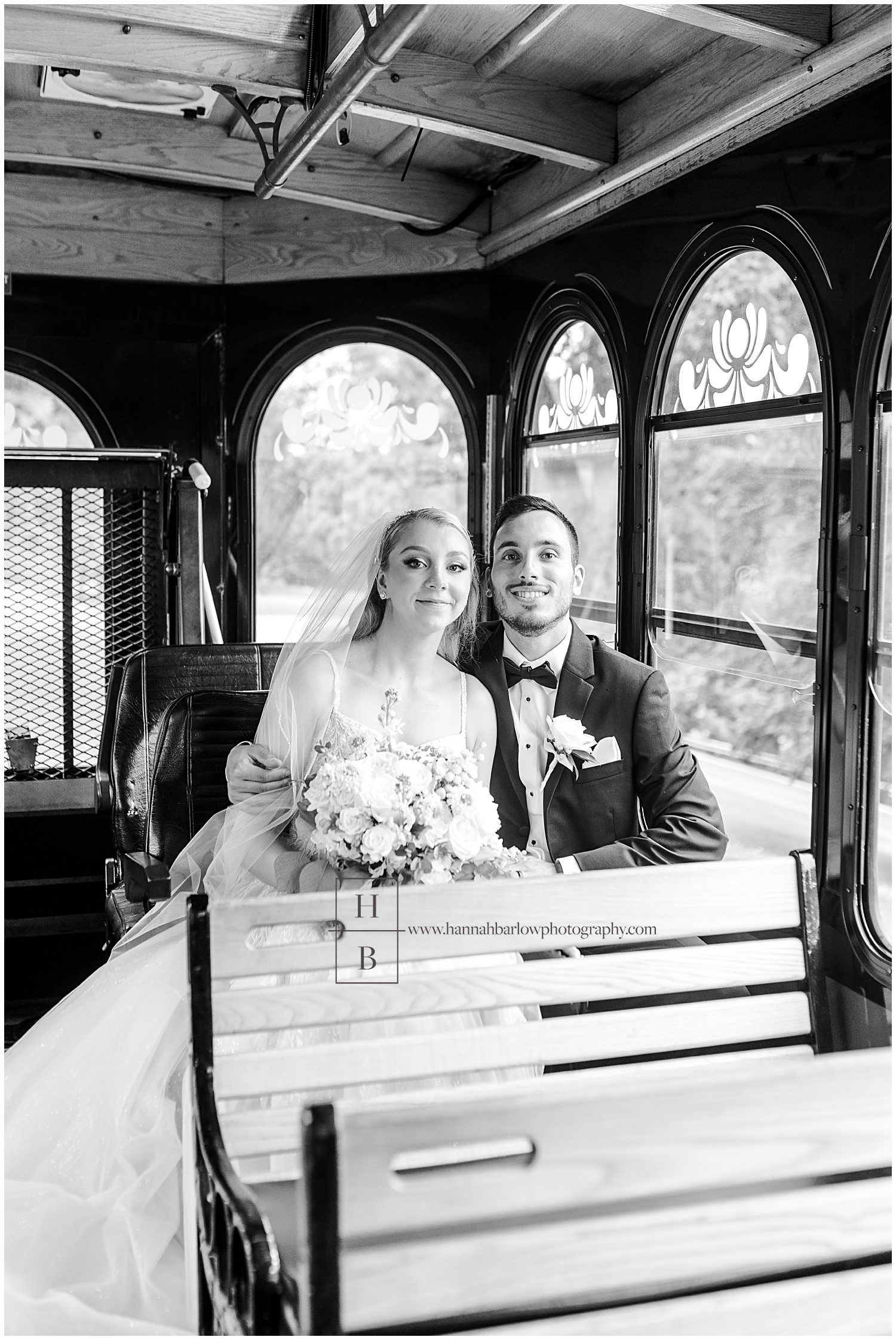 Bride and groom pose in trolley.