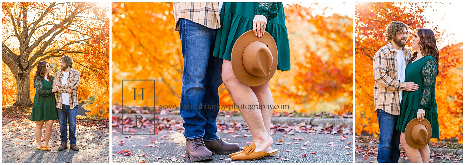 Woman in green holds hat and poses with man for engagement photos.