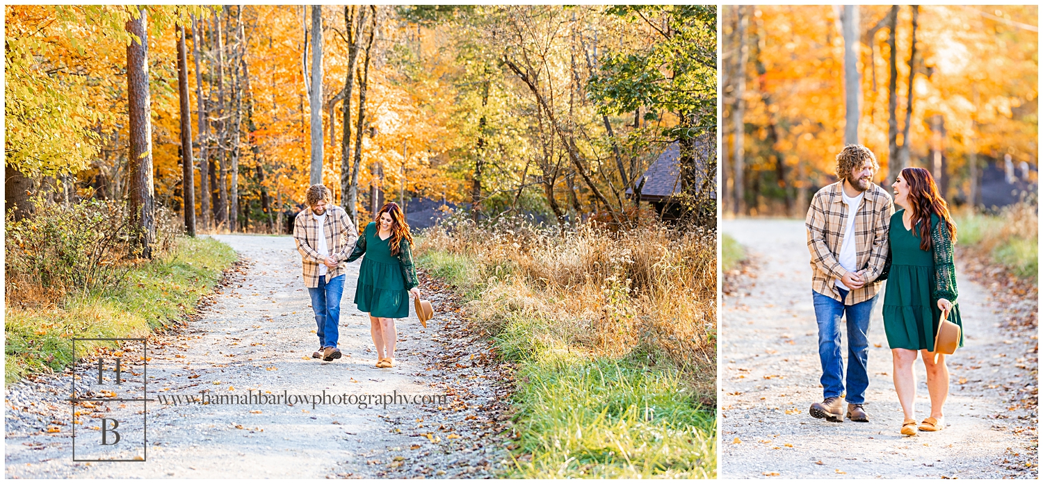 Couple walks down gravel path during fall.