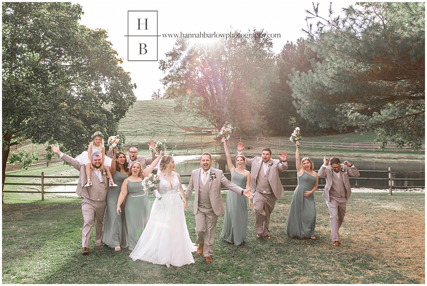 Bridal party walks together with beautiful golden hour behind them.