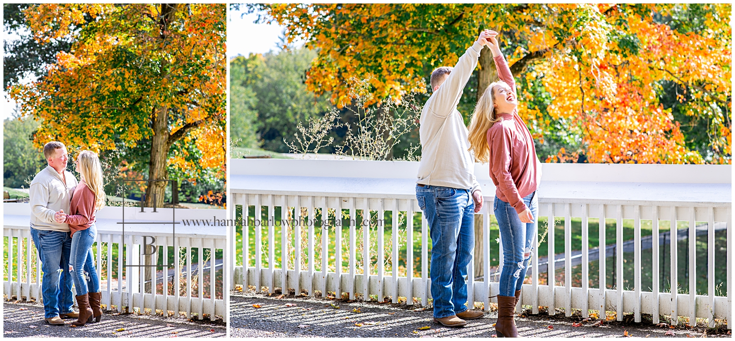 Man in white sweater spins woman in peach dress for fall dancing photos.