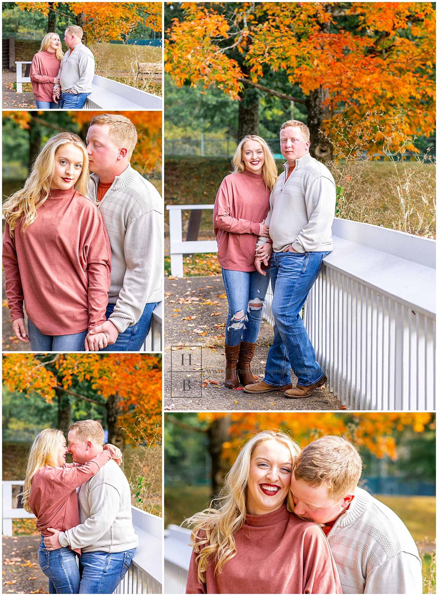 Couple stands by white fence with fall trees in the background for engagement photos.