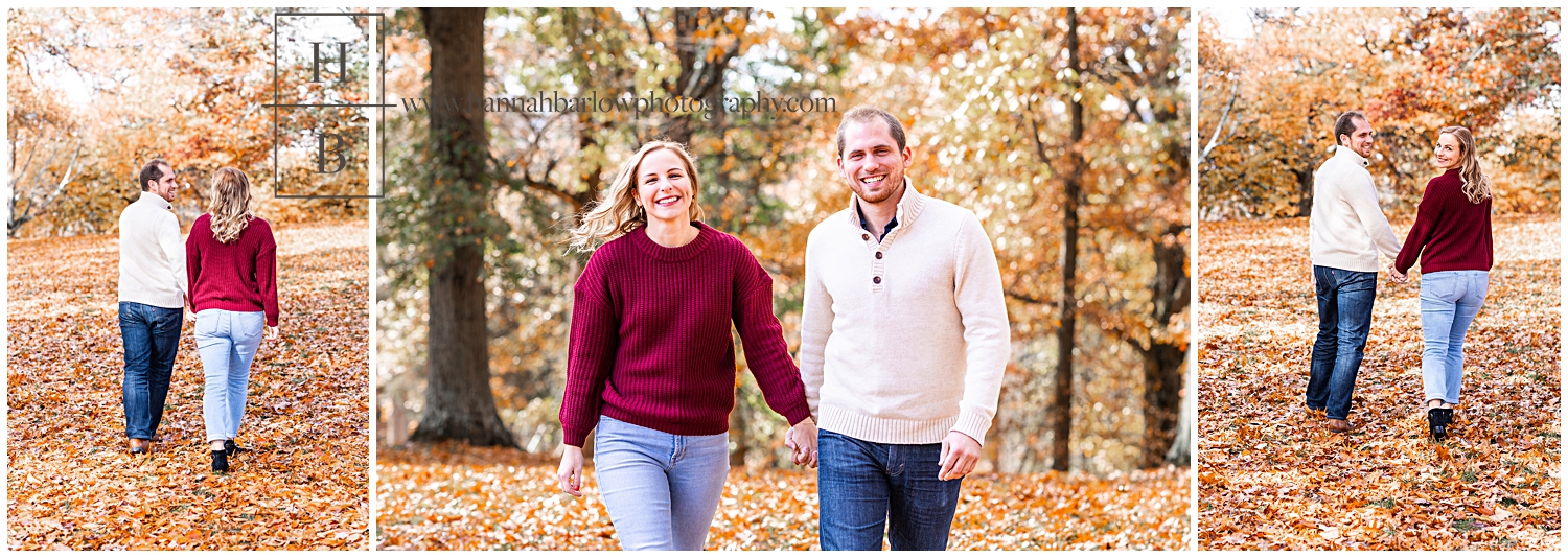 Man and woman walk hand in hand for engagement photos in orange leaf forest