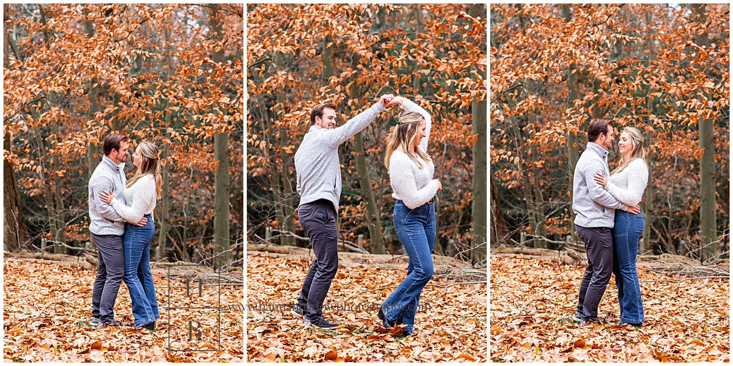Man dances with woman in fall leaves for engagement photos