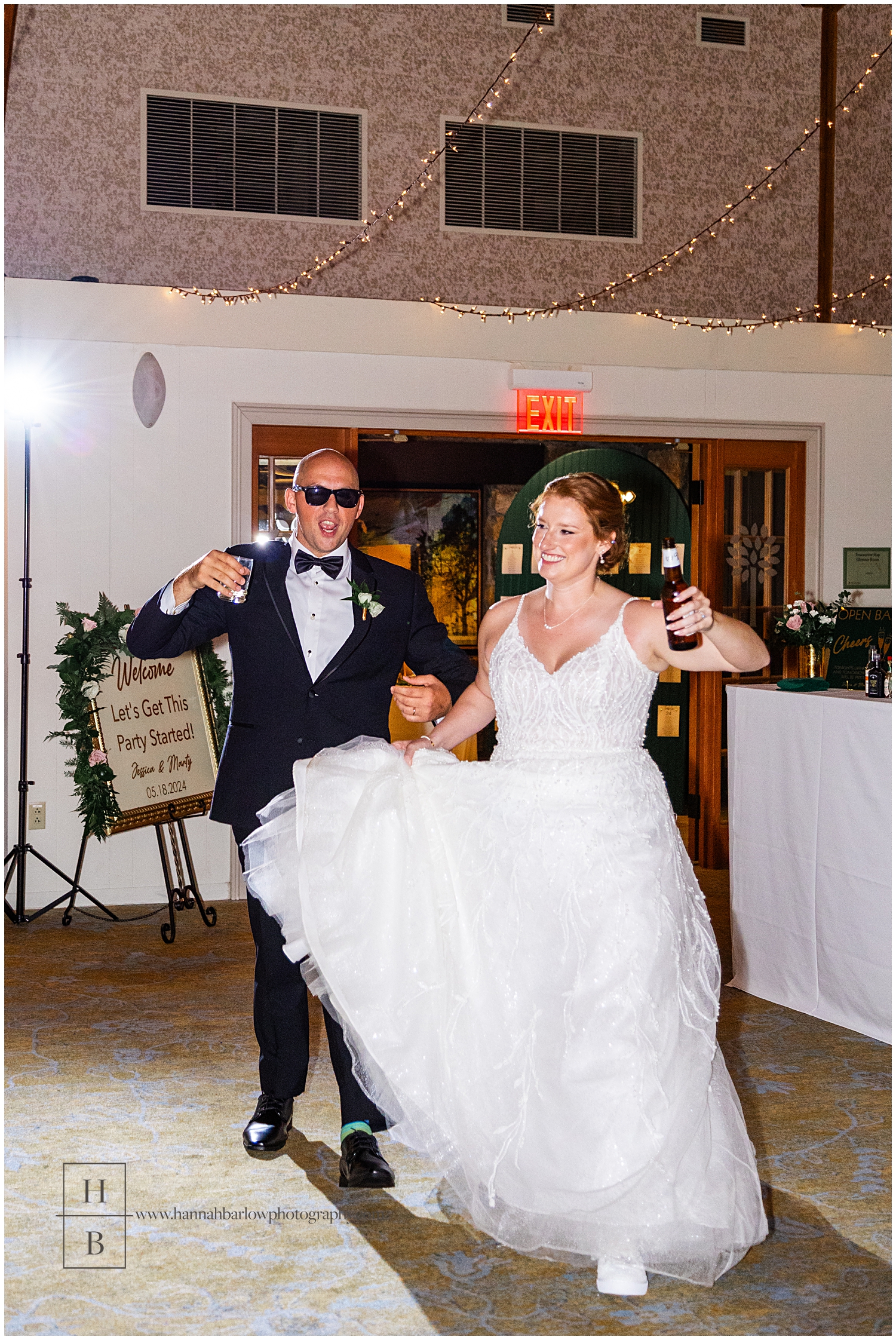 Bride and groom enter reception with drinks in hand