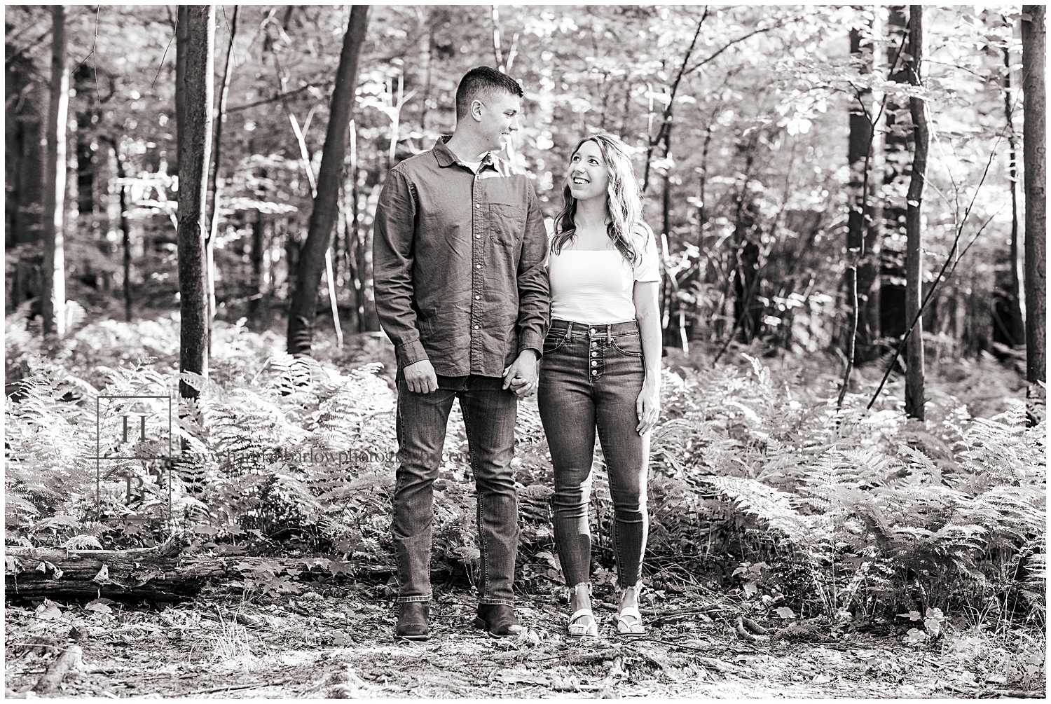 Black and white photo of man and woman looking at each other for engagement photos