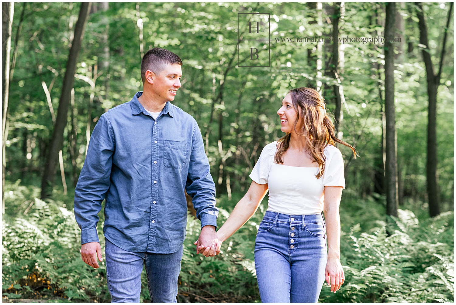 Man and woman walk hand in hand for engagement photos