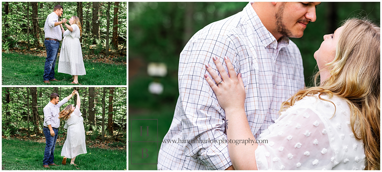 Couple dances and snuggles for engagement photos in forest tree-line