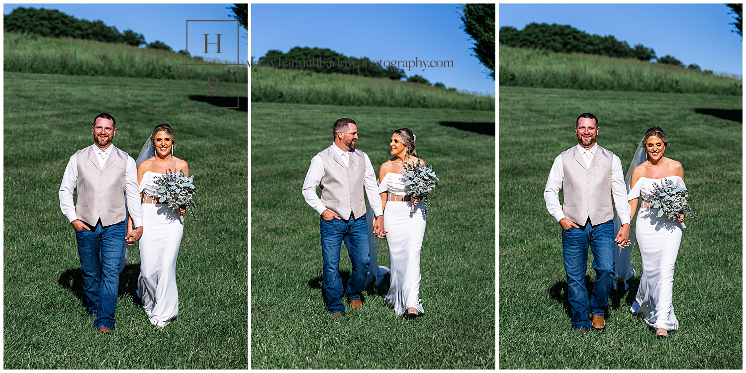 Bride and groom walk hand in hand looking at one another