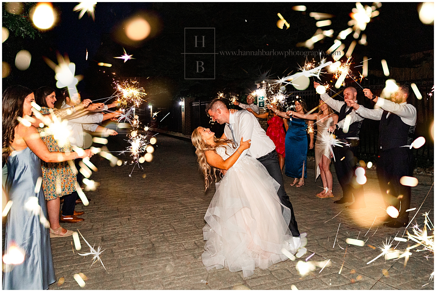 Bride and groom dip for sparkler exit