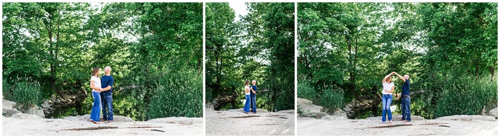 Couple stands on rocks by creek for engagement photos