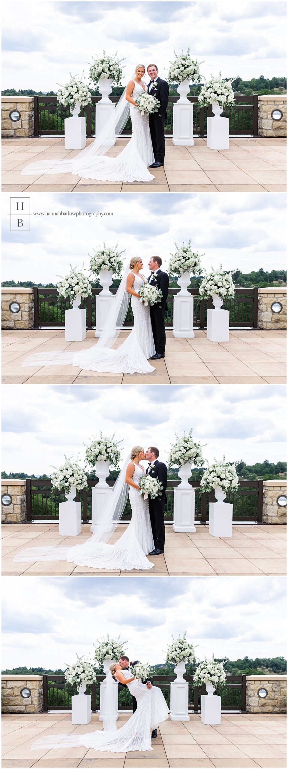 Bride and groom pose by large white flower arrangements