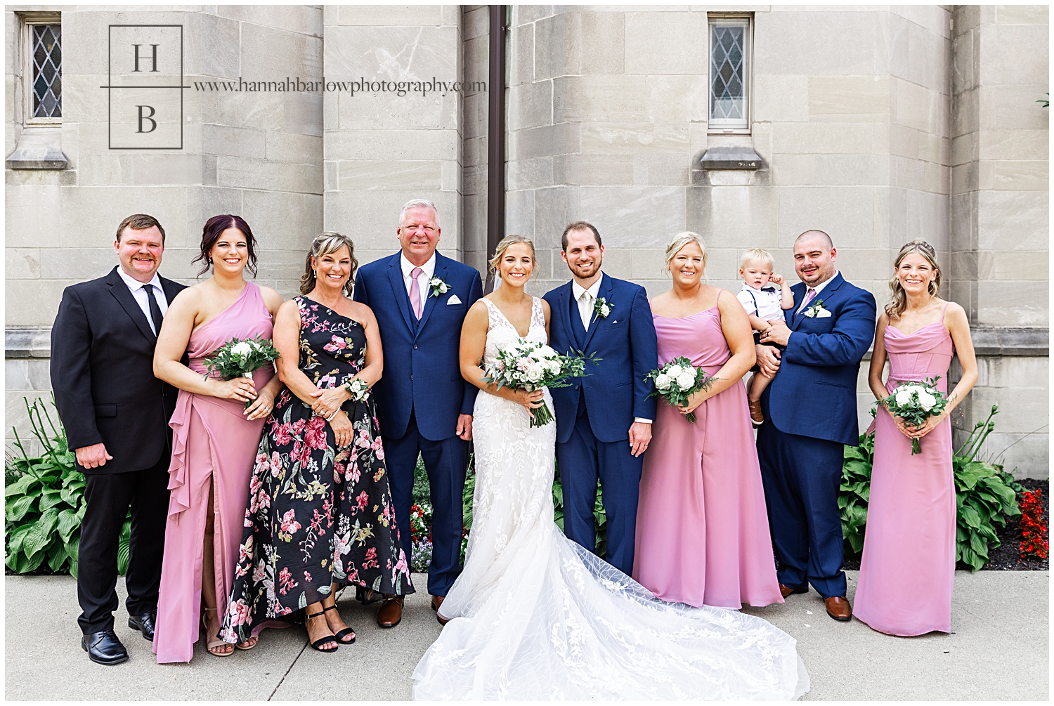 Bride poses with family outside