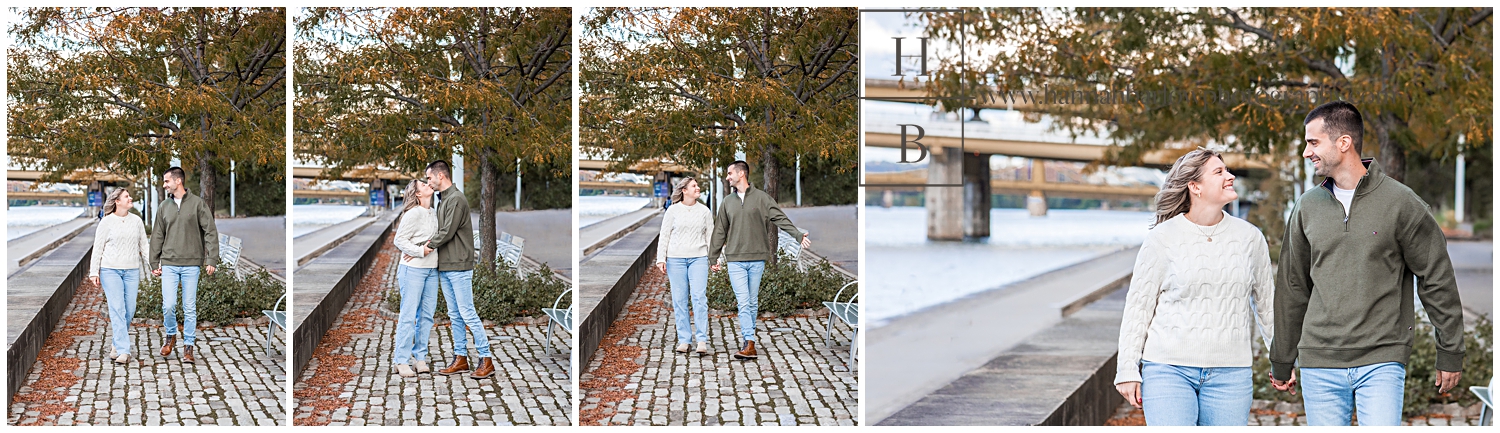 Couple wearing sweaters walk on Stone