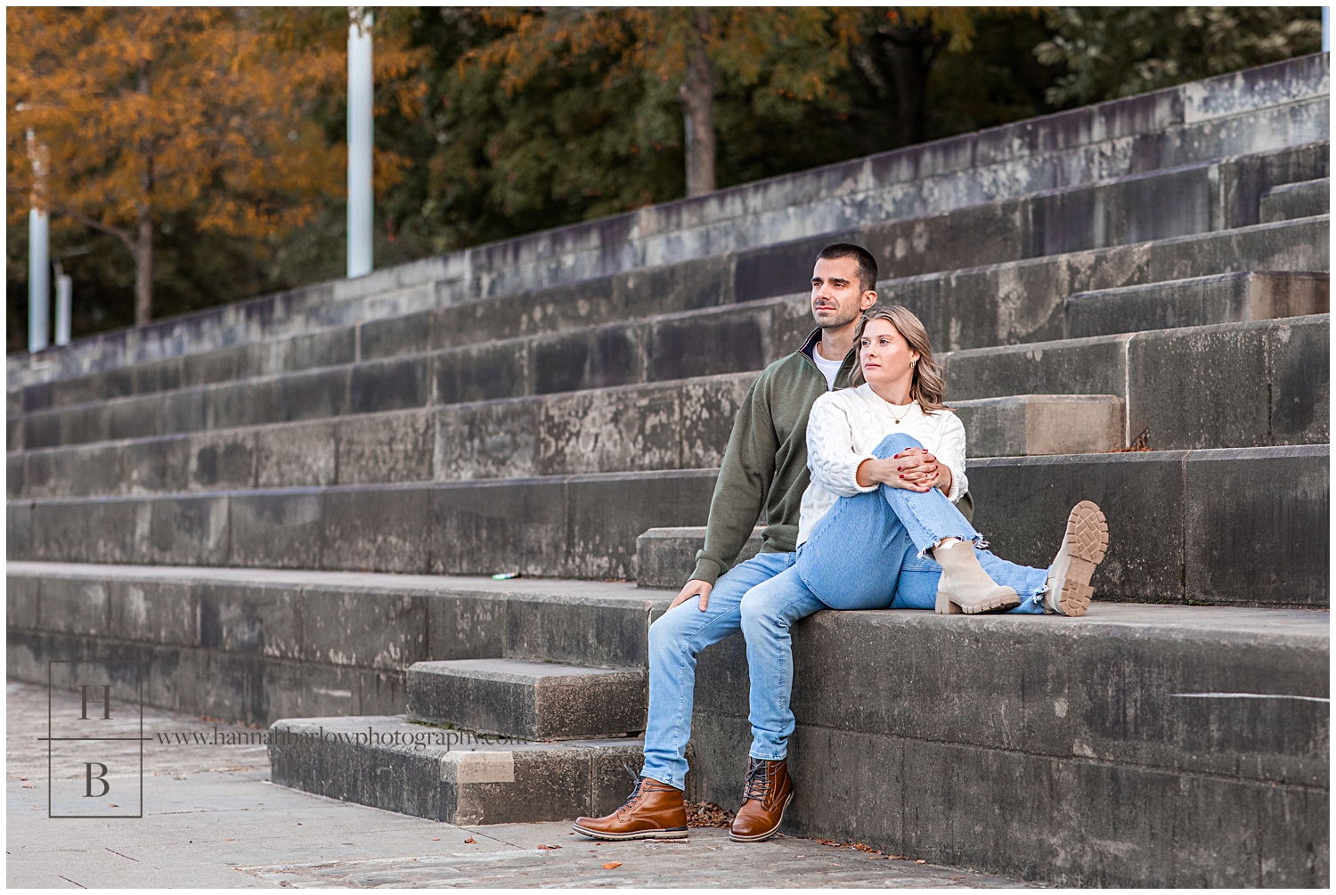 Couple sits on stone steps and gaze away