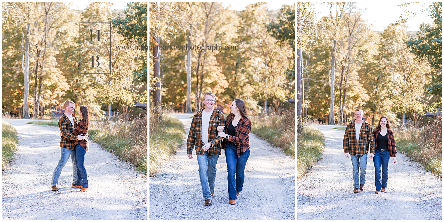 Couple walks down gravel path wearing plaid