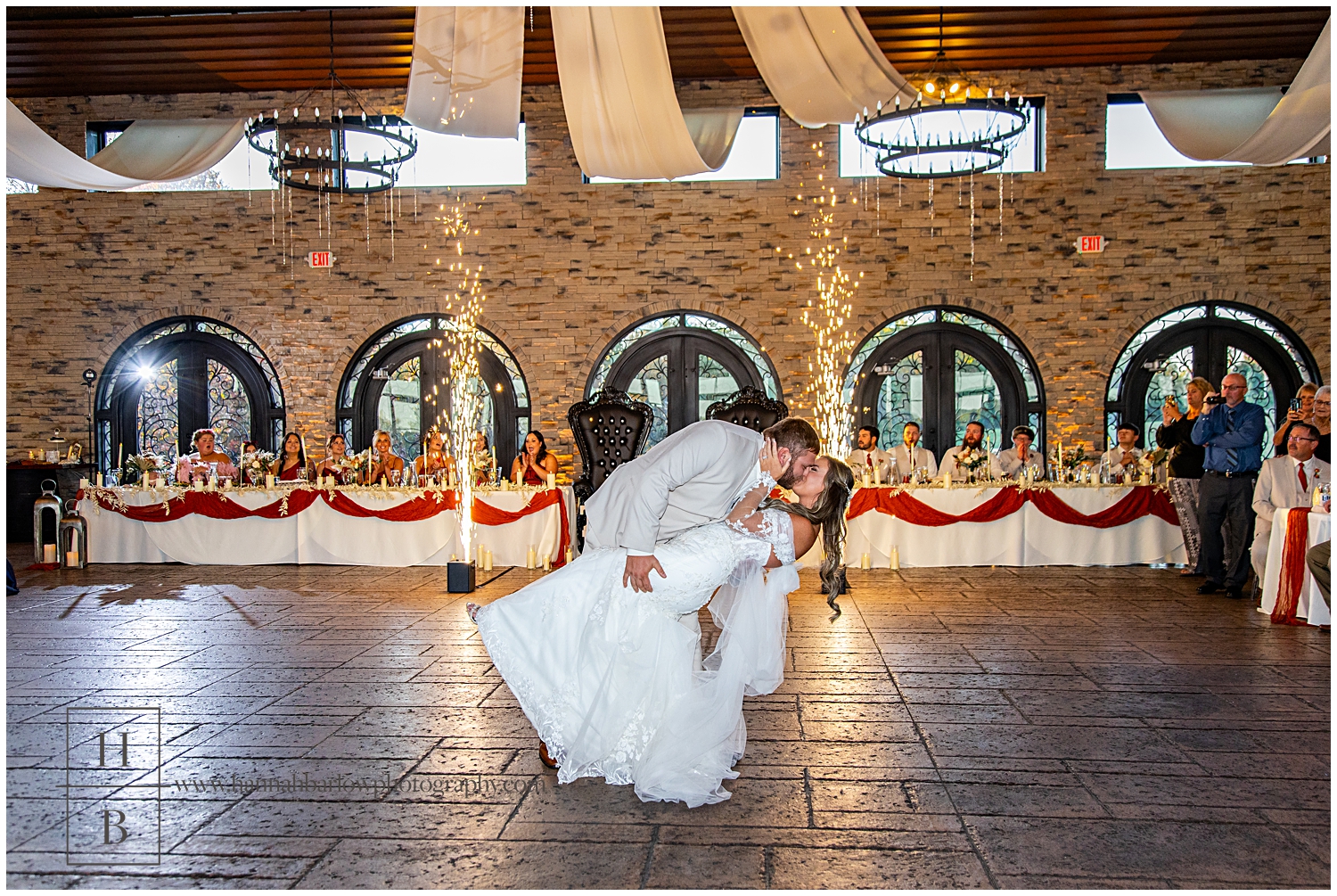 Couple dips during first dance with sparklers going off in background