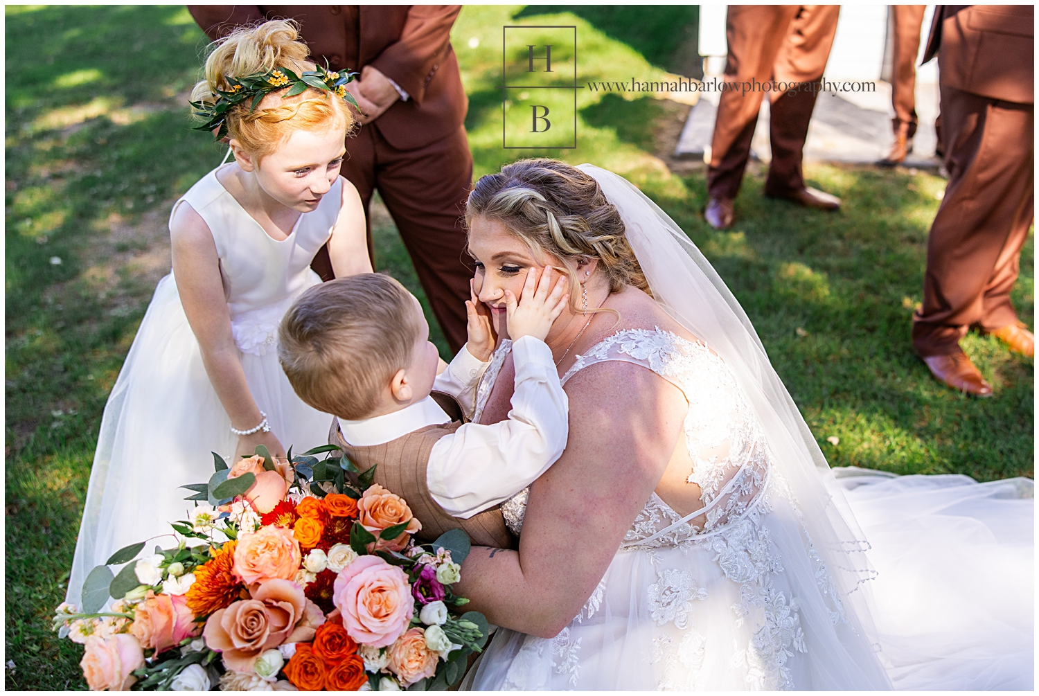 Ring bearer squishes brides cheeks for kiss