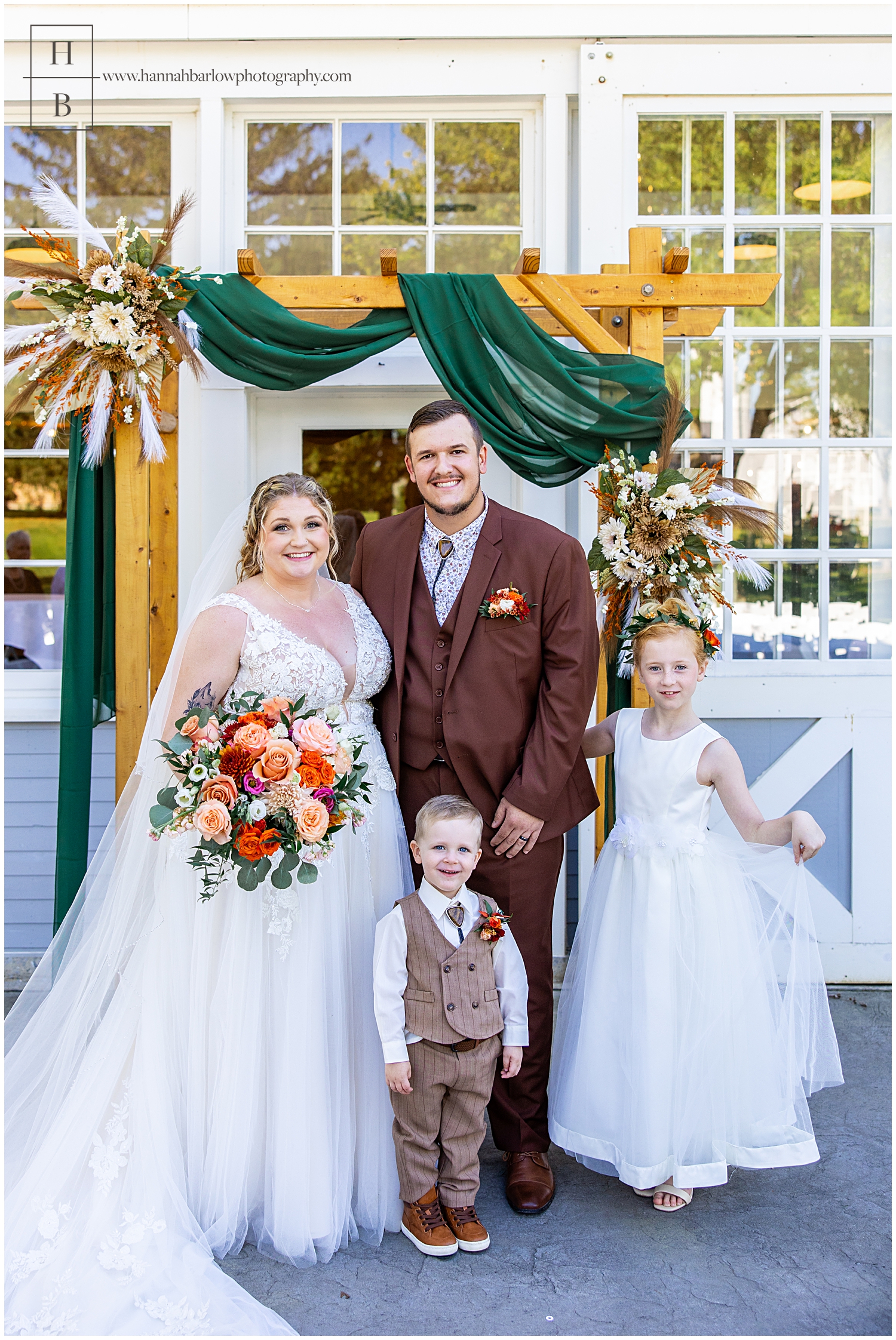 Bride and groom pose with flower girl and ringbearer