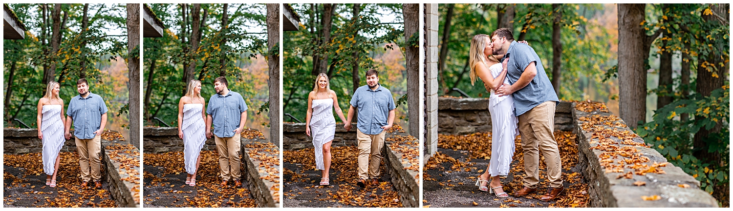 Man and woman embrace and walk for engagement photos