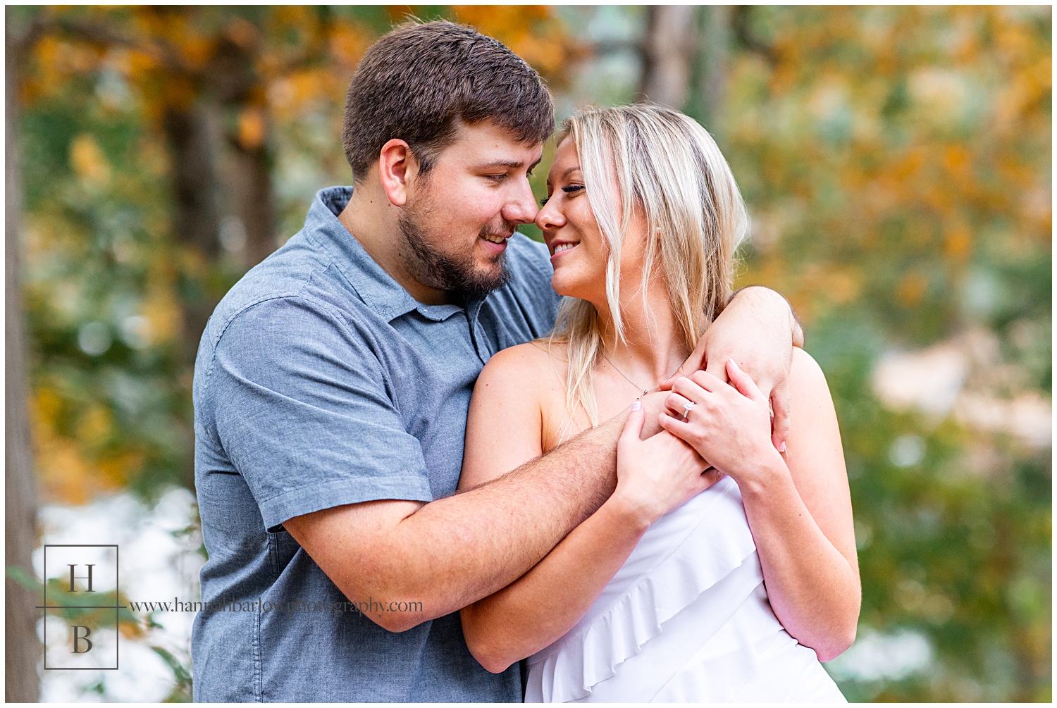 Men and blue shirt snuggles fiancé and white dress