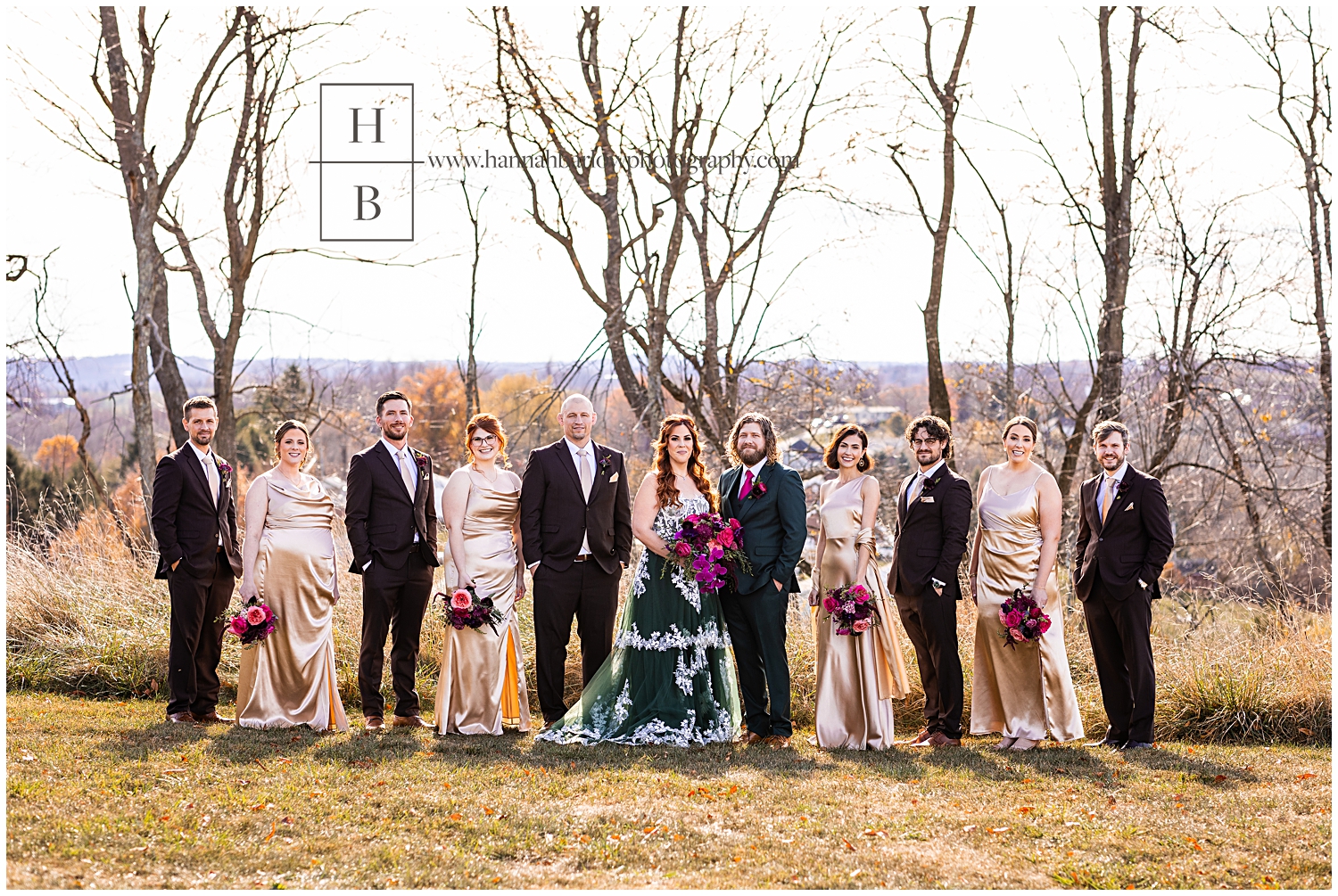 Groomsman in brown taxes purse with bridesmaids and champagne dresses standing with bride and groom