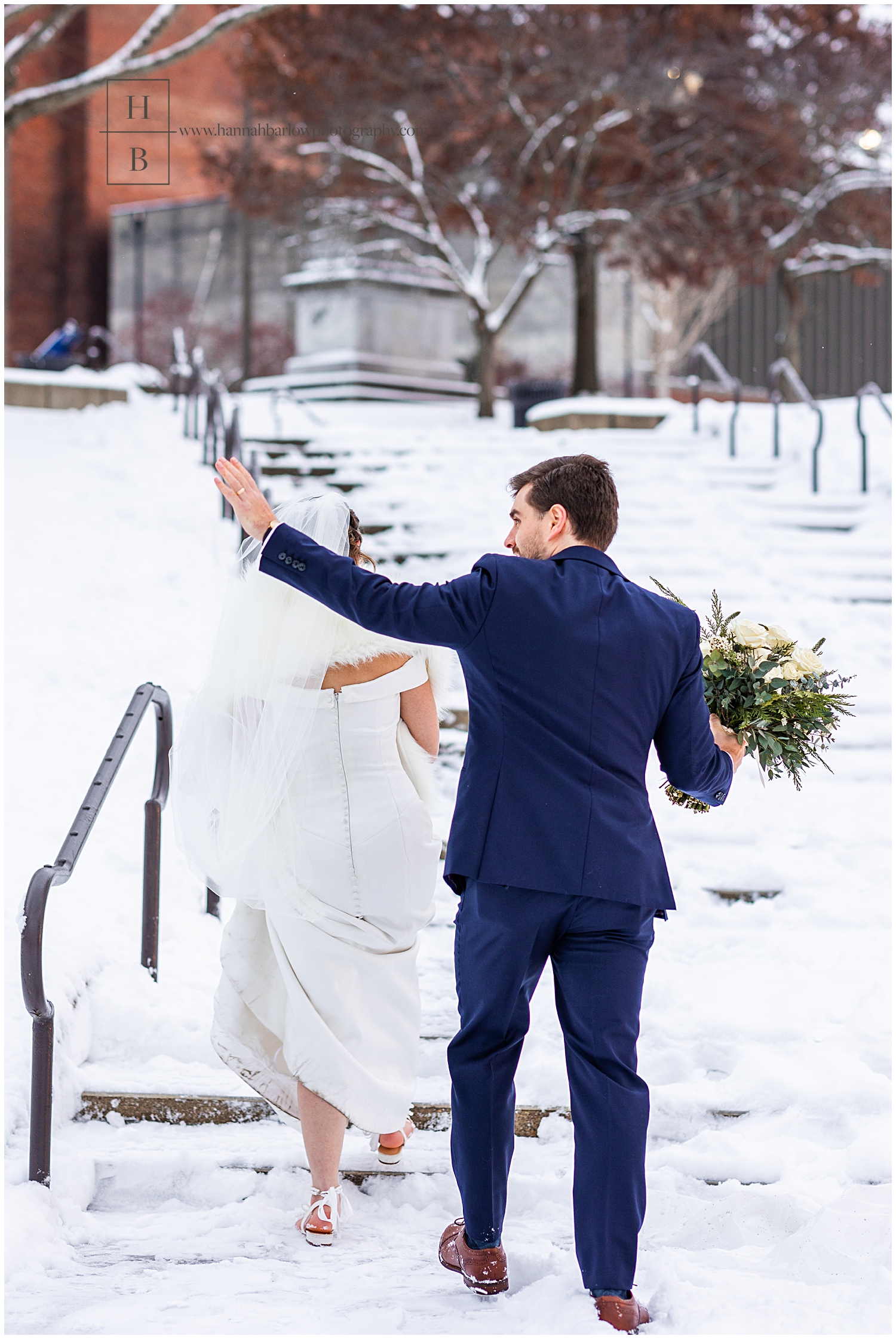 Groom waves as they walk up the stairs