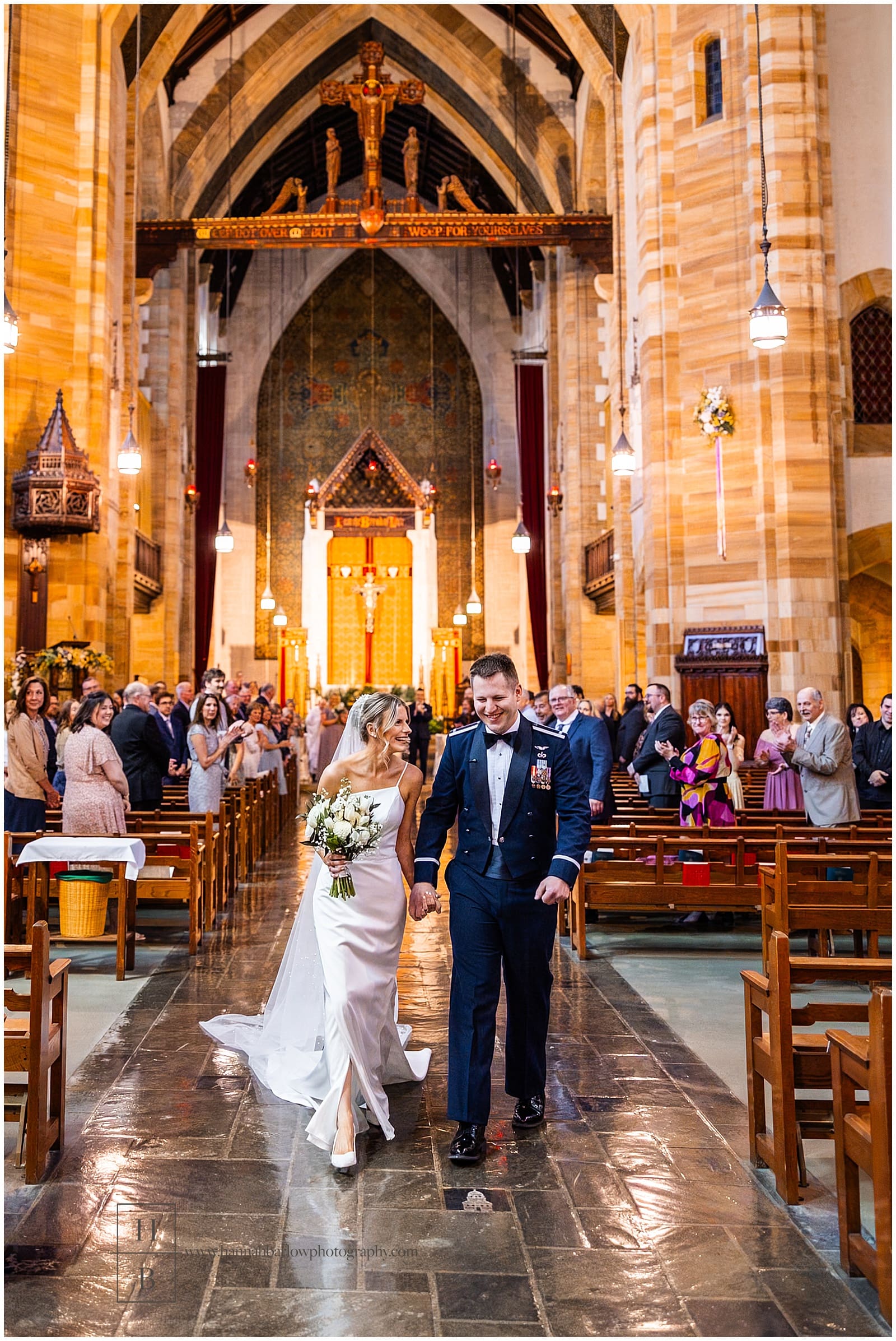 bride and groom walk down aisle after catholic ceremony