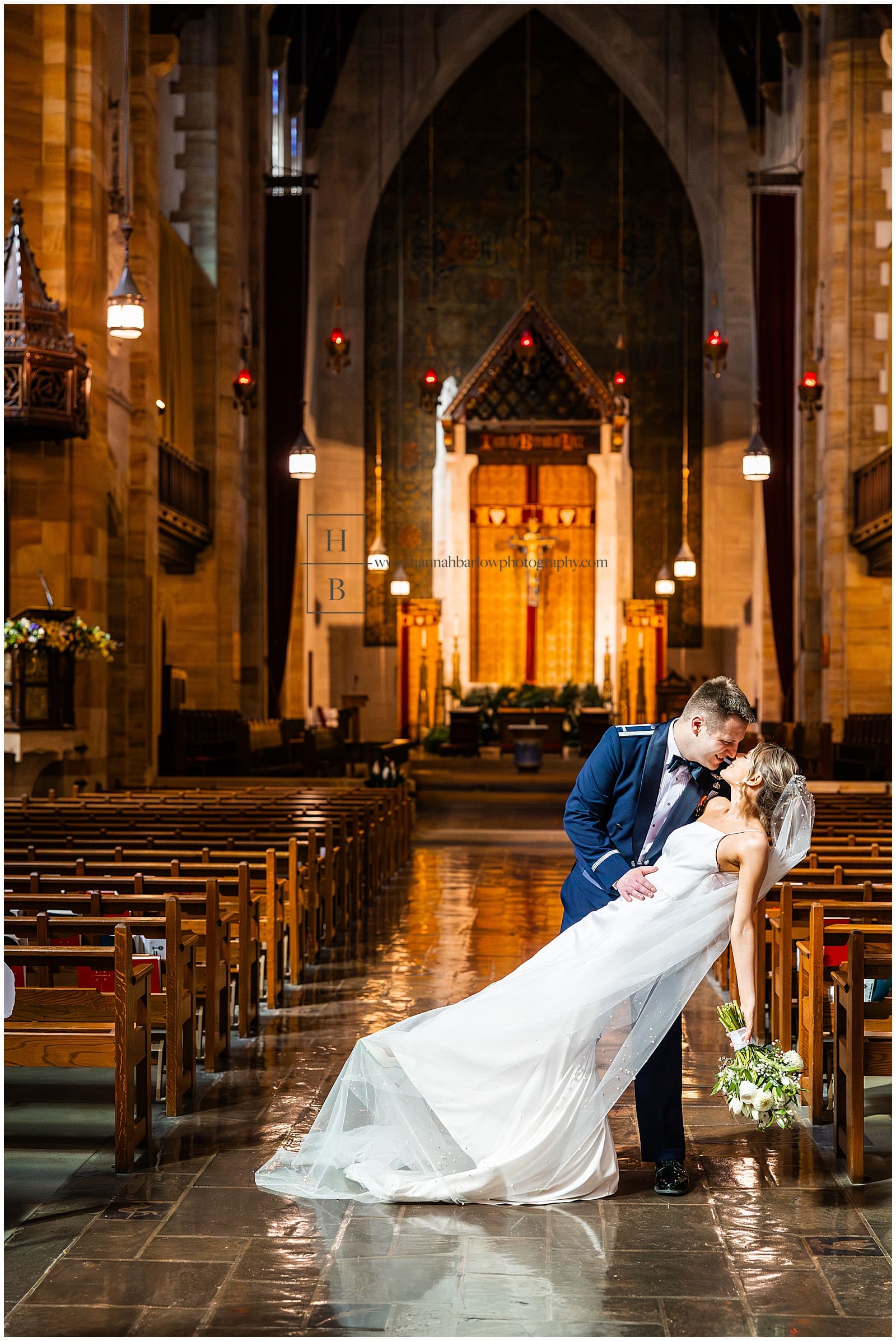 groom dips bride inside church for dramatic photo