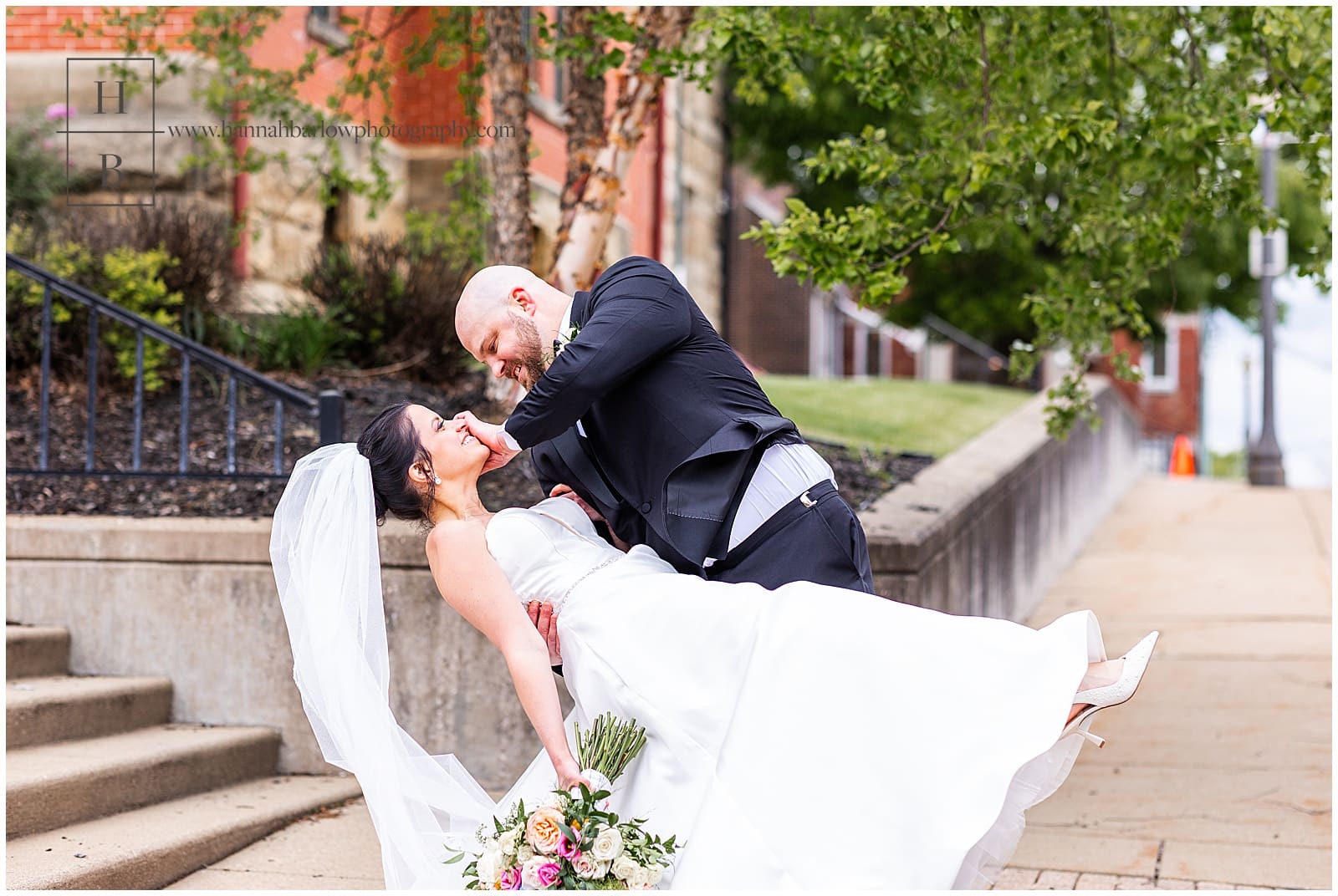 Groom dips bride and moves hair out of her face