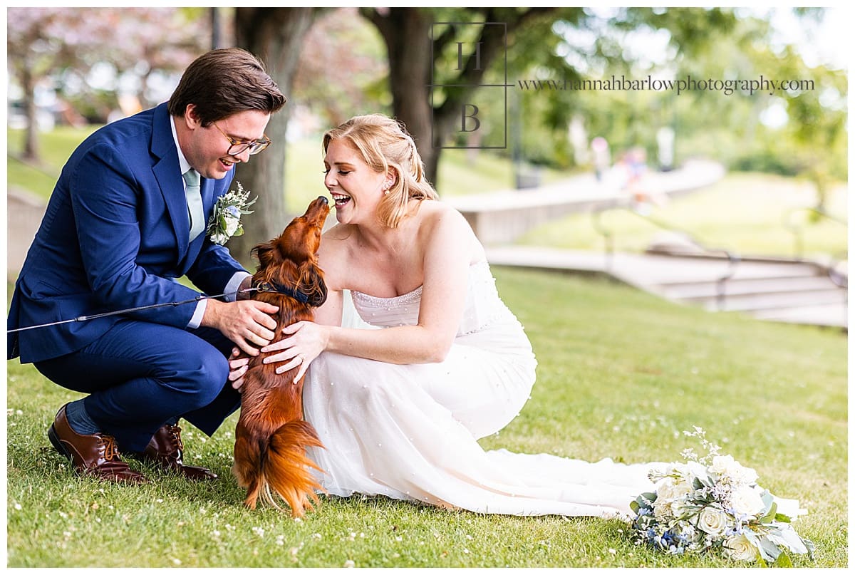 Bride and groom spend time with excited dog