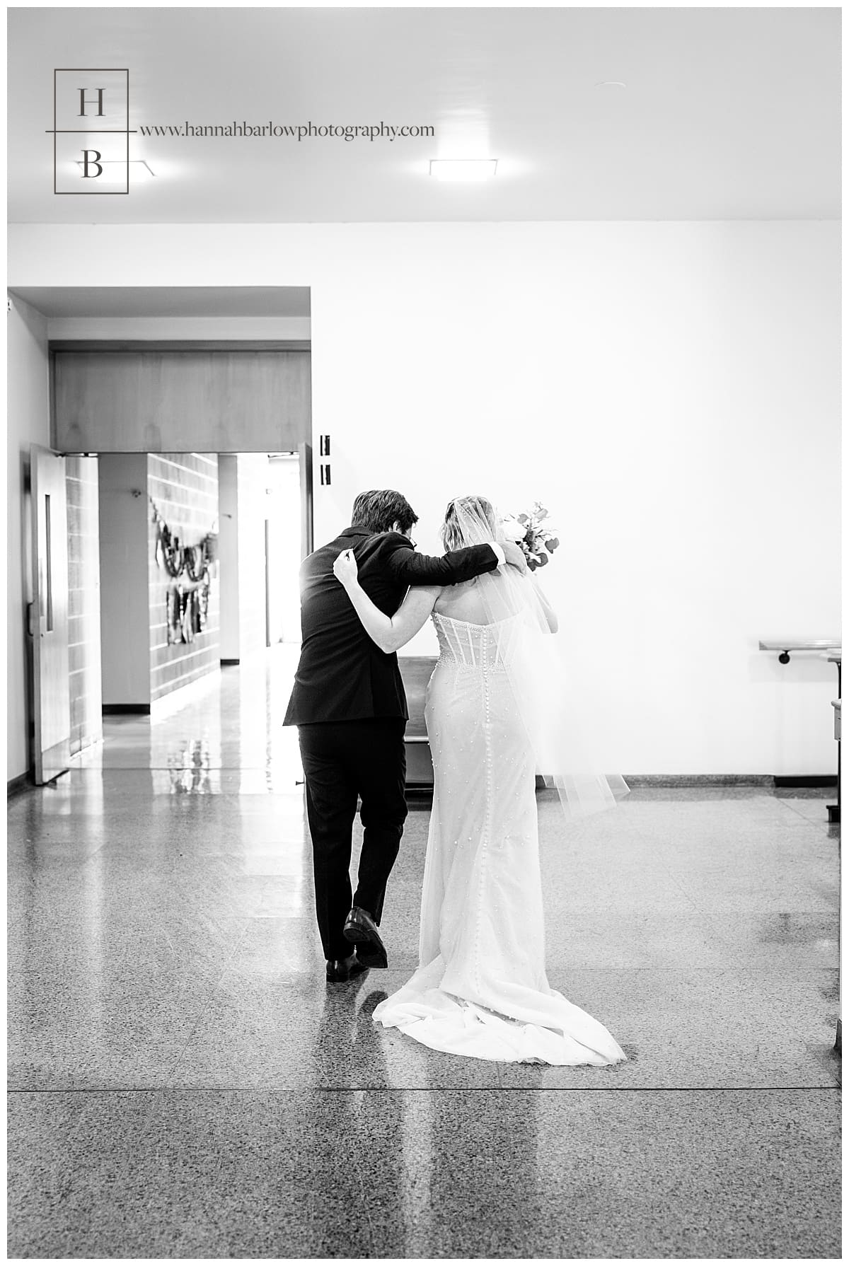 black and white photo of couple walking inside church