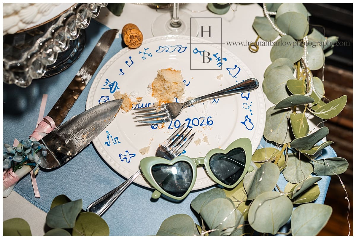 wedding cake on plate with heart glasses