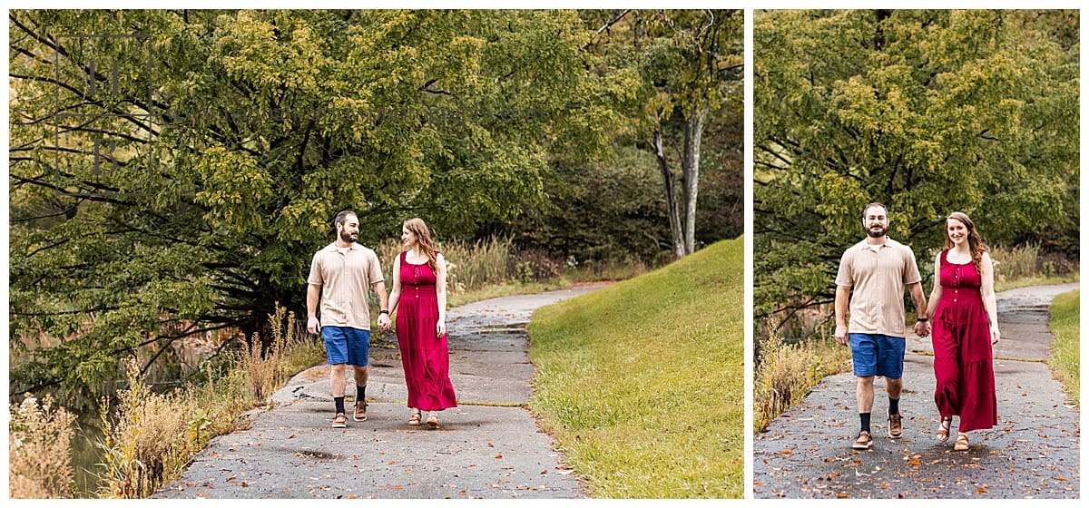 couple walks hand in hand down grey asphalt path