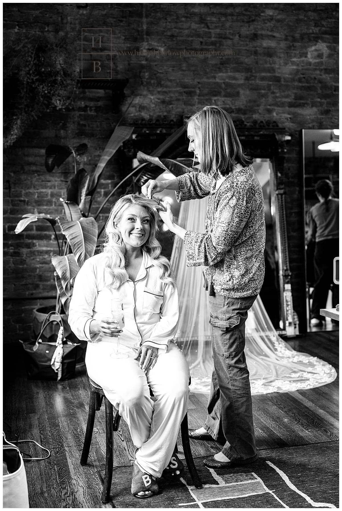 black and white photo of bride getting hair done
