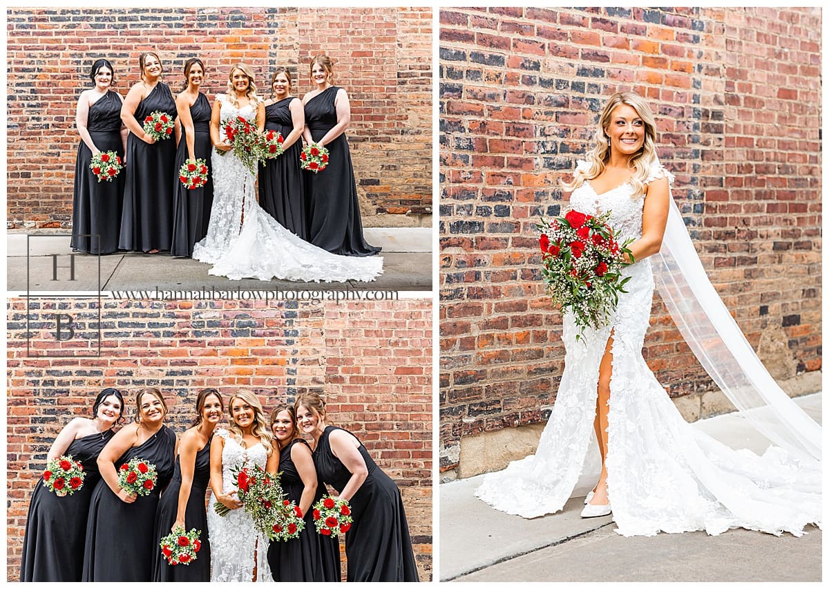 bride poses with bridesmaids in black dresses holding red rose bouquet 