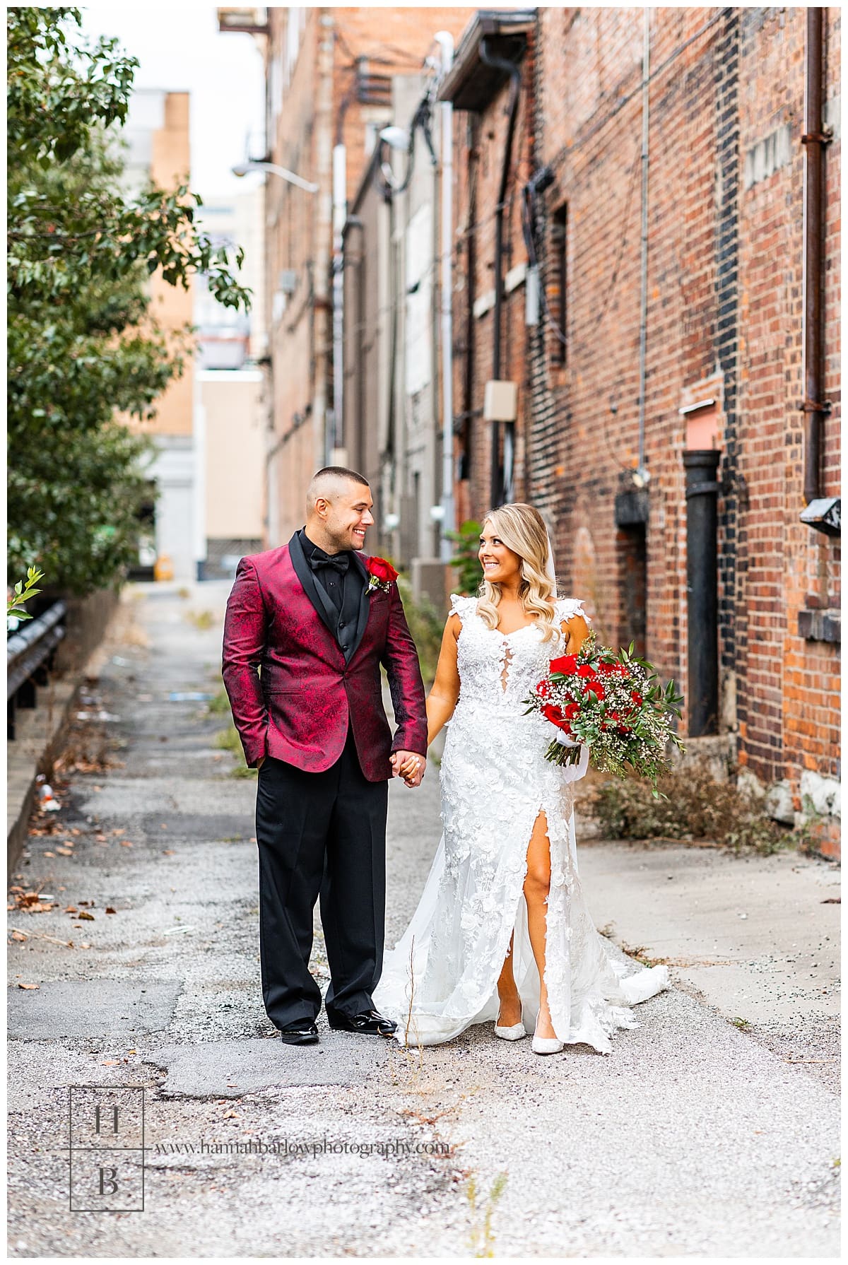 bride and groom walk down alley