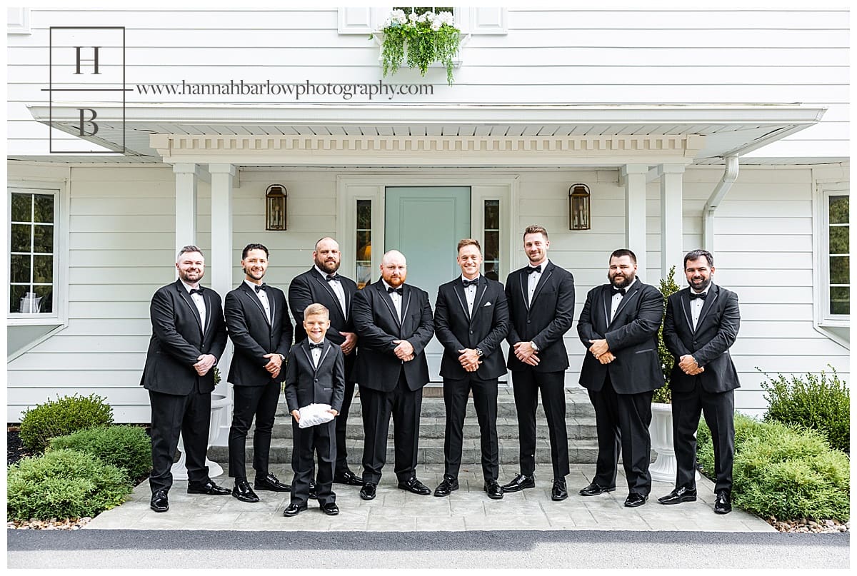 groomsmen pose outside for wedding photo